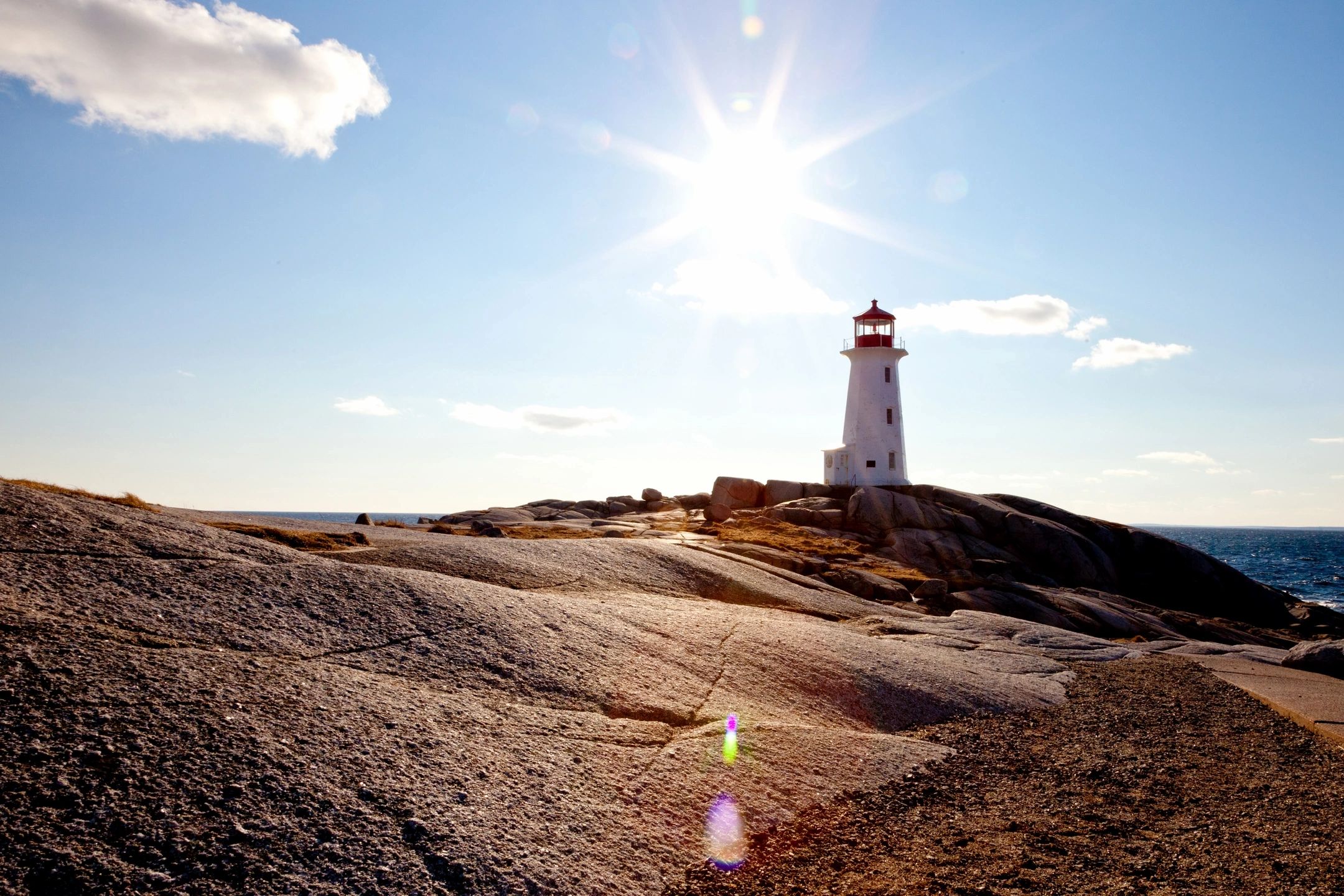 Lighthouse family therapy - a white lighthouse with the sun shining brightly